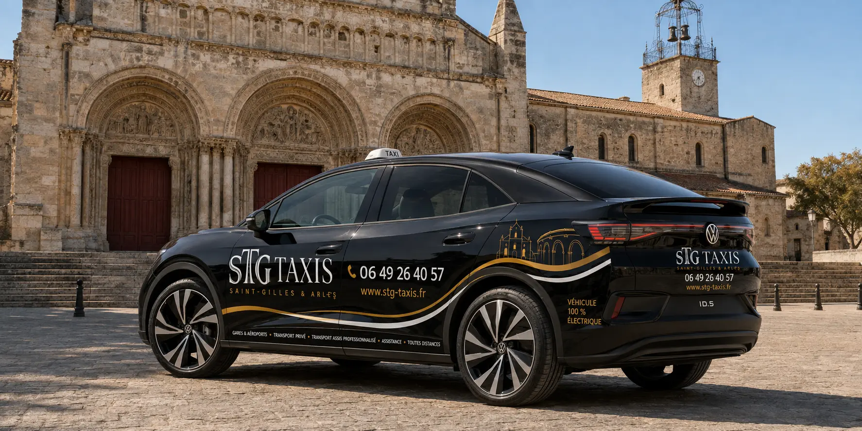 Volkswagen ID.5 noire STG Taxis devant l’abbatiale de Saint-Gilles